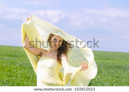 Portrait of a young woman wrapped in yellow cloth