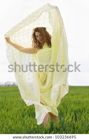 Sensual young woman wrapped in yellow cloth