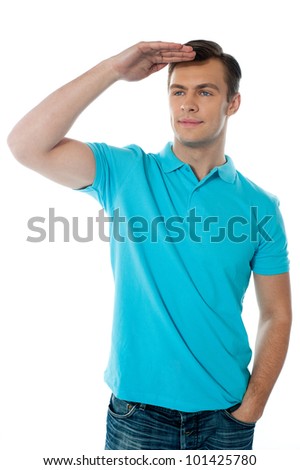 Cool young chap posing with hand on his head, seeking far far away
