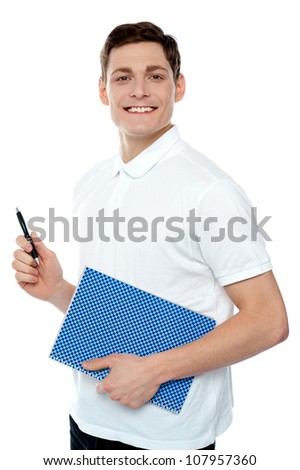 Smiling young man with notepad and pen against white background