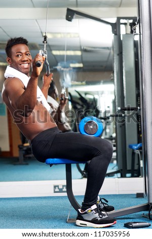 Fit african trainer working out in gym. Keeping fit and healthy