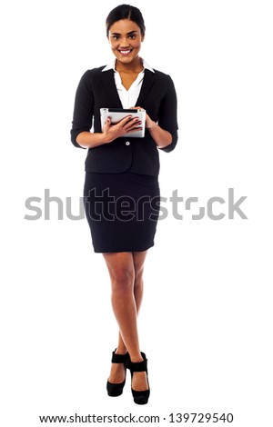Full length studio shot of a corporate woman operating touch pad