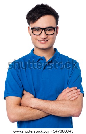 Smiling young guy posing with arms crossed
