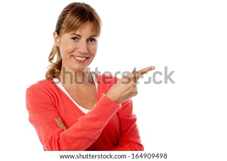 Cute middle aged lady model pointing away