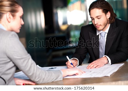 Corporate lady explaining business concepts to her colleague