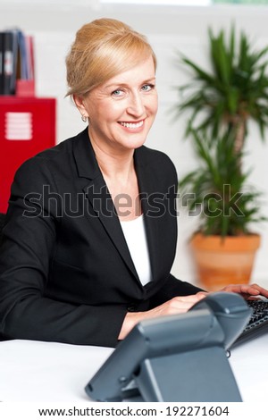 Middle aged woman working at desk