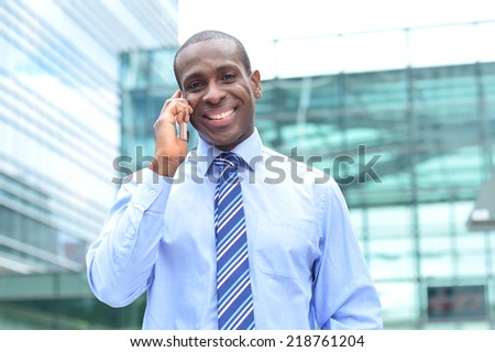 Corporate guy talking on cell phone outside the office