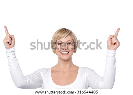 Woman pointing upwards in success