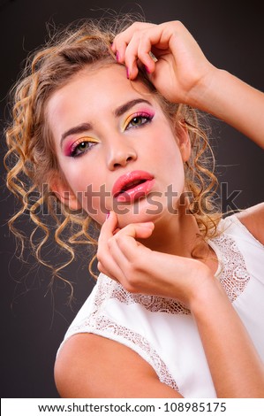 Beautiful woman with volume and shiny curly hair style, bright lips make-up