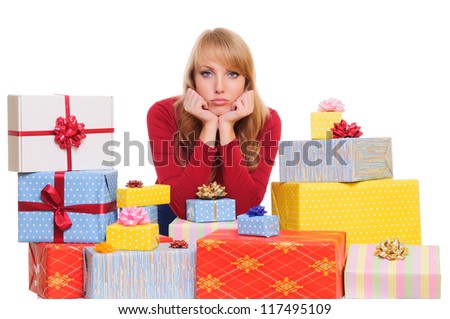 sad beautiful young woman and a pile of gift boxes. isolated on white background