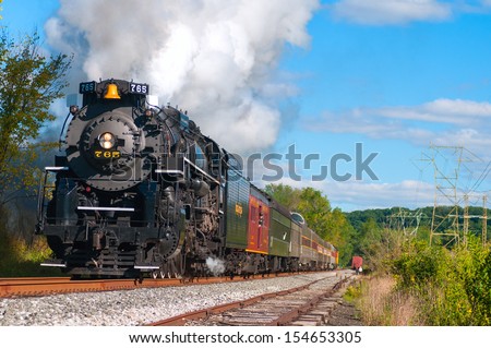 BRECKSVILLE, OH - SEPTEMBER 14: A vintage steam engine on the Cuyahoga Valley Scenic Railroad, thunders through Brecksville Ohio on September 14 2013. \