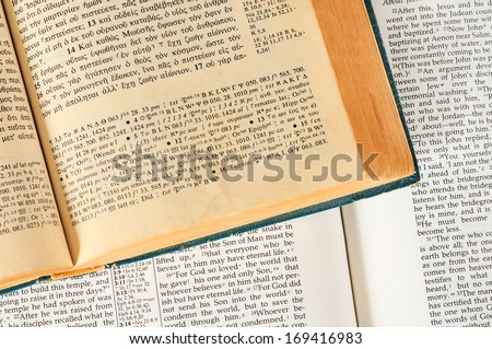 TWINSBURG, OH - JANUARY 16, 2011: Photo of two open Bibles, one in Greek, the other in English, illustrating the concept of researching the original language in Christian Bible study.