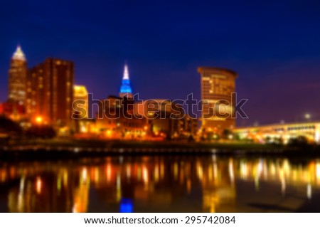 Downtown Cleveland Ohio as seen from the west bank of the Cuyahoga River at blue hour, blurred for artistic effect