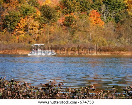 Autumn lake with pontoon boat