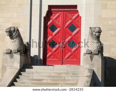 Stone lions at entrance to chime tower in a cemetery