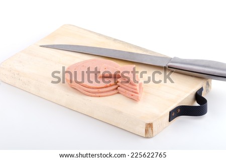 Sliced vegetarian bologna sausage on cutting board and knife