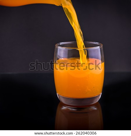 fresh squeezed orange juice, pouring orange juice from a bottle into a glass