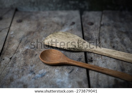 old wooden cooking spoon on wood background, still life