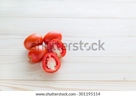 Tomatoes, cooked with herbs for the preservation on wooden table