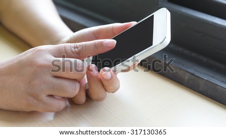 Hand touch the Screen on the Smart Phone, Close-up image with shallow depth of field focus on finger