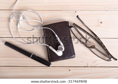 brown wallet, spectacles,earphones, pen vintage style