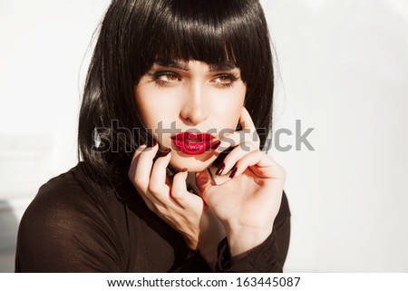 Vogue Style Woman with red lipstick and black short hair. glossy smooth fashion Hair Beautiful brunette girl with bright makeup. Hairstyle. isolated on white background. Red lips, red nails.Sexy look
