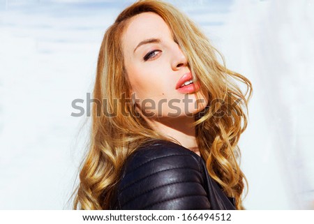 Portrait of the beautiful girl close-up , wind fluttering hair. Outdoors shot . Street