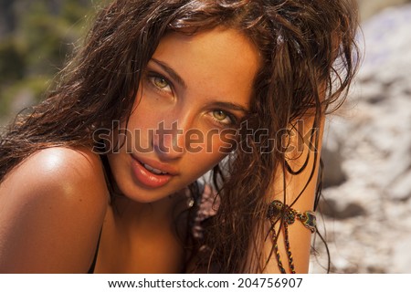 Beautiful woman face with bright makeup and wavy hair .Summer fashion style. Toned in warm colors. Copy Space for your text horizontal shot.