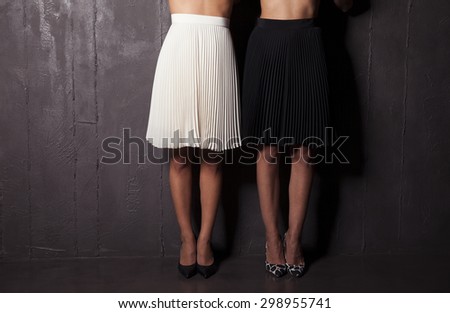 women legs in high heel shoes and short black and white skirt  , studio shot. horizontal