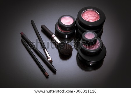 Makeup products on dark background with copy space for your text. studio shot. Horizontal picture