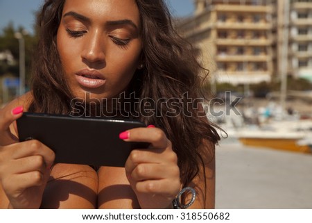beautiful woman using her smart phone. Copyspace for your text. Beauty and technology. horizontal outdoors shot.
