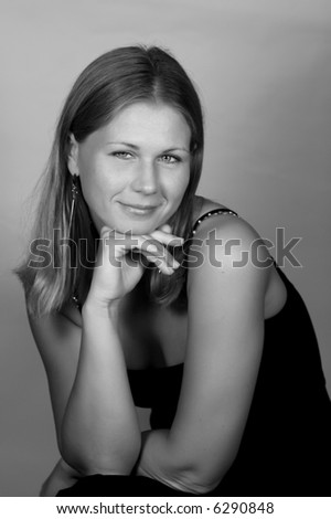 monochrome portrait of stylish young woman looking at you with kind smile