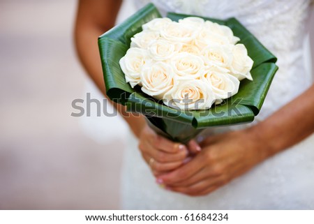 Bride holding roses vivid flowers bouquet in hands