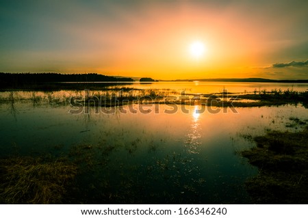 colorful sunset over the flooded lake
