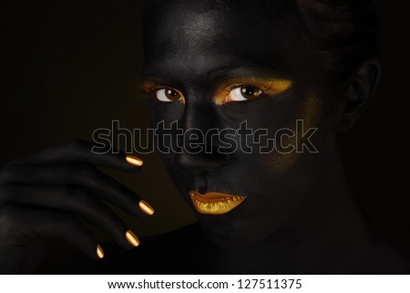 Beautiful black face isolated on black