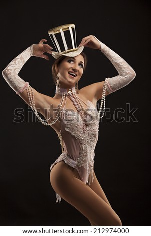 Burlesque dancer in white dress with hat, isolated on black