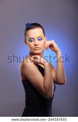 beautiful young woman with blue creative make-up studio