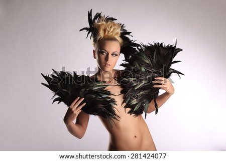 Portrait of woman shaman with raven feather in her hair studio