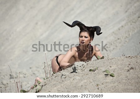 The beautiful young girl with horns like devil or angel outdoor