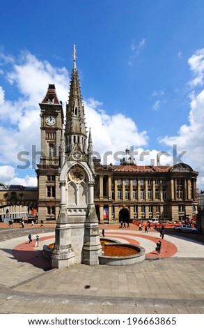 BIRMINGHAM, UK - MAY 14, 2014 - Chamberlain memorial in Chamberlain Square with the clock tower of Birmingham museum and art gallery to the rear, Birmingham, West Midlands, UK, May 14, 2014.