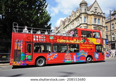 OXFORD, UNITED KINGDOM - JUNE 17, 2014 - Red open topped Oxford tour bus along St Aldates, Oxford, Oxfordshire, England, UK, Western Europe, June 17, 2014.