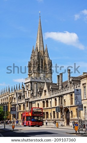 Oxford, United Kingdom - June 17, 2014 - All Souls College and the spire of the University Church of St Mary to rear along High Street, Oxford, Oxfordshire, England, UK, Western Europe, June 17, 2014.