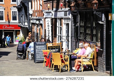 SHREWSBURY, UNITED KINGDOM - APRIL 22, 2015 - People relaxing at pavement cafes along Butcher Row during the Springtime, Shrewsbury, Shropshire, England, UK, Western Europe, April 22, 2015.