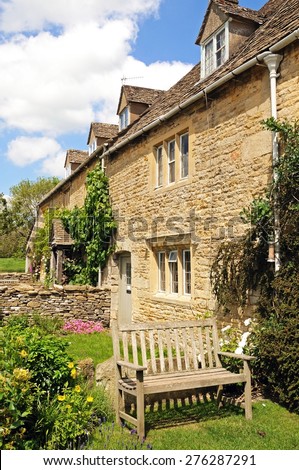 LOWER SLAUGHTER, UK - JUNE 12, 2014 - Pretty stone cottages in the centre of the village, Lower Slaughter, Cotswolds, Gloucestershire, England, UK, Western Europe, June 12, 2014.