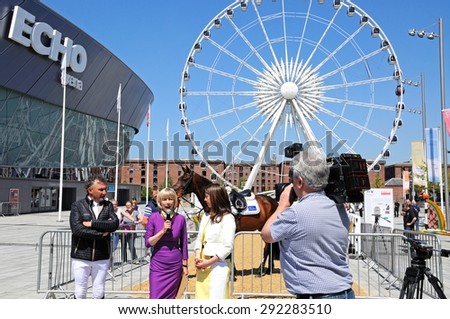 LIVERPOOL, UK - JUNE 11, 2015 - TV presenter interviewing the Showjumper Peter Charles to promote the launch of the Liverpool International Horse Show 2016, Liverpool, UK, June 11, 2015.