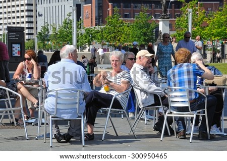 LIVERPOOL, UNITED KINGDOM - JUNE 11, 2015 - People relaxing at a pavement cafe at the side of Ferry Terminal at Pier Head, Liverpool, Merseyside, England, UK, Western Europe, June 11, 2015.