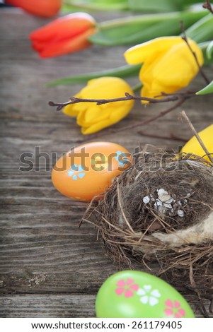 Easter composition with nest and eggs on a wooden table