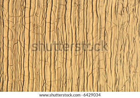 a cracked gold background that could either be wood or fabric depending on how you view it.