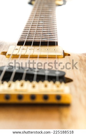 Stringed electric guitar neck and pickup with strings closeup.