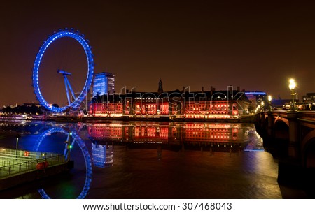LONDON, ENGLAND - October 17, 2014 - London England\'s Thames River Reflection, Skyline, and London Eye at night.